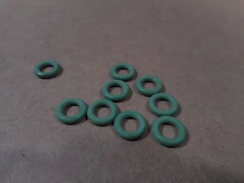 Mehrere grüne O-Ringe auf einer hellen Unterlage, die möglicherweise für Remeha-Produkte verwendet werden.